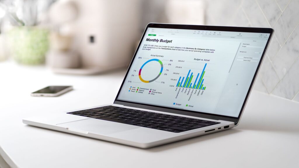 Gray laptop with a monthly budged report with graphs