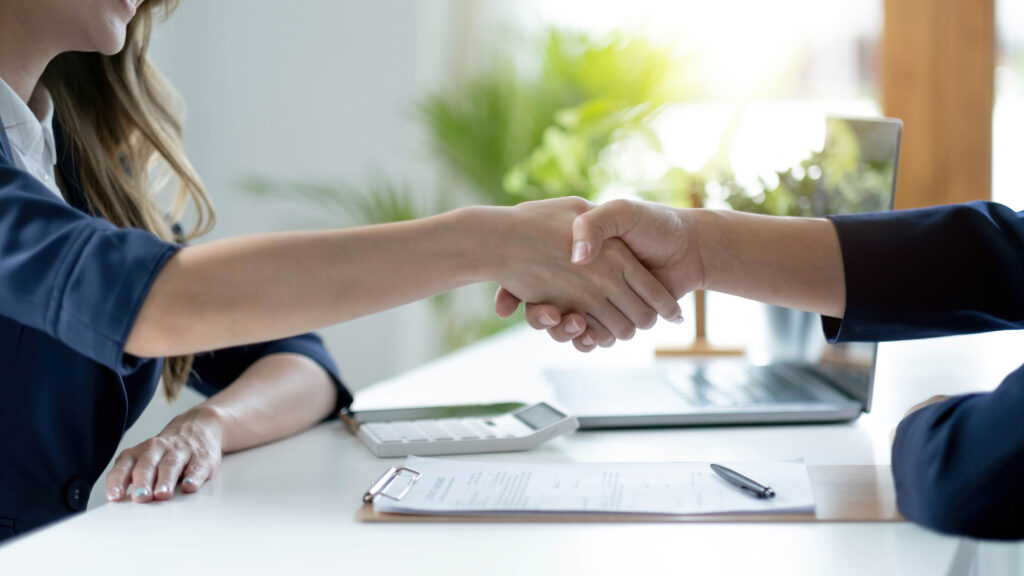 Homebuyers celebrating successful property deal with agent