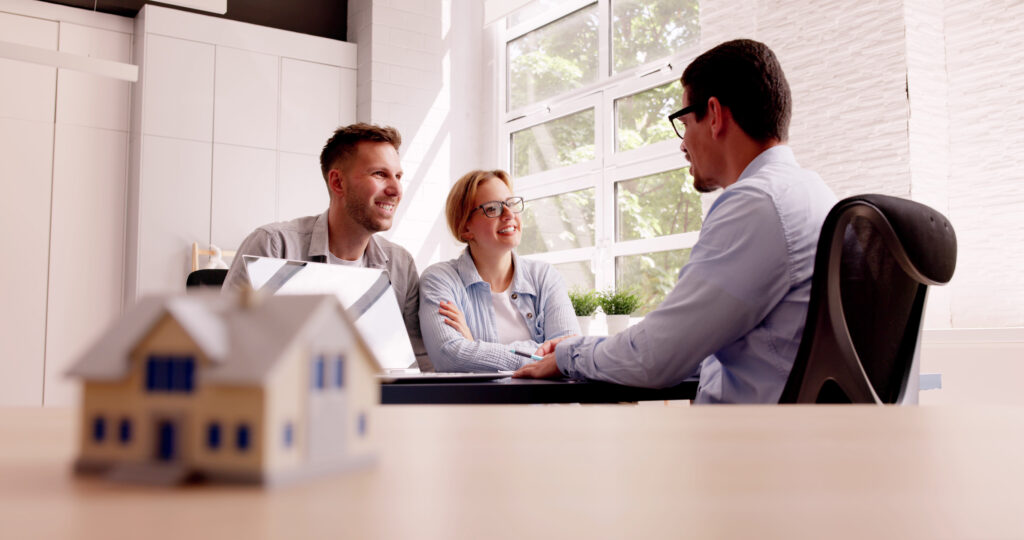Couple finalising purchase agreement for new home