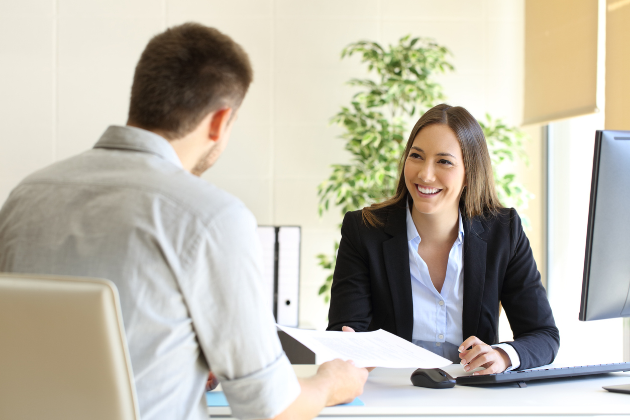 Man giving bridging loan document to a woman