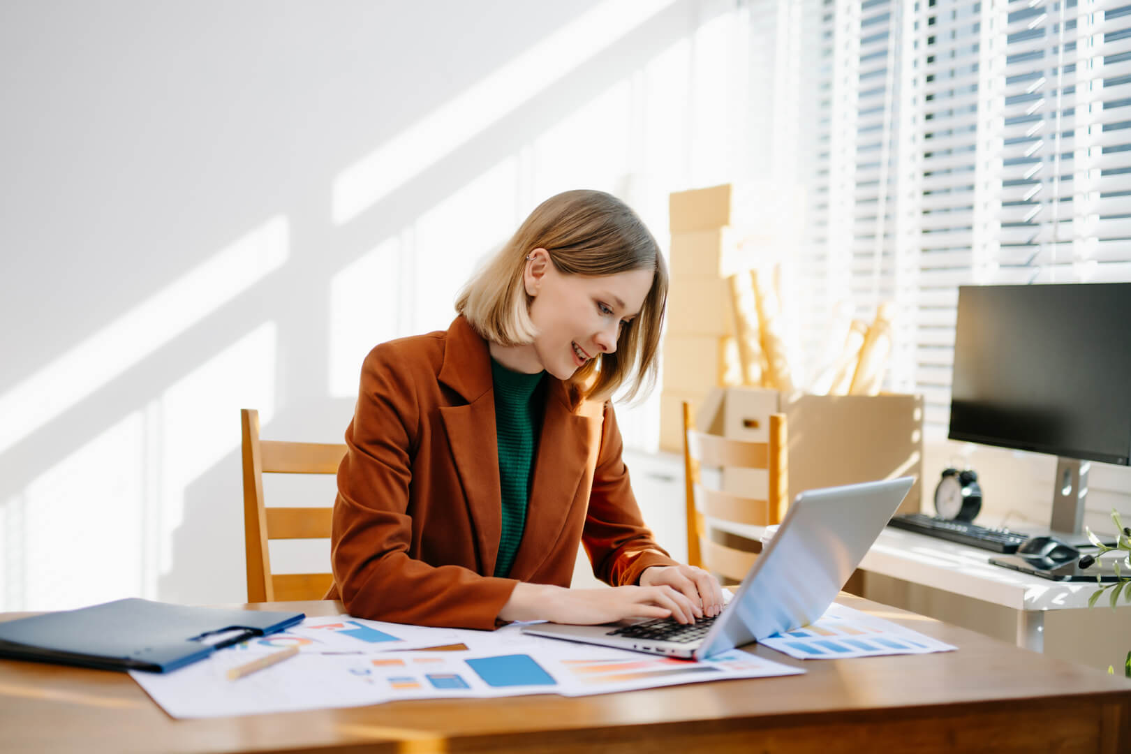 Mortgage broker in Canberra comparing bridging loan options with a client using charts and documents in a modern office.
