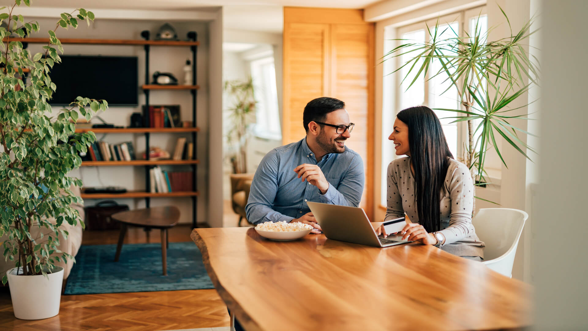 Adelaide couple reviewing property listings at home while planning bridging finance before selling