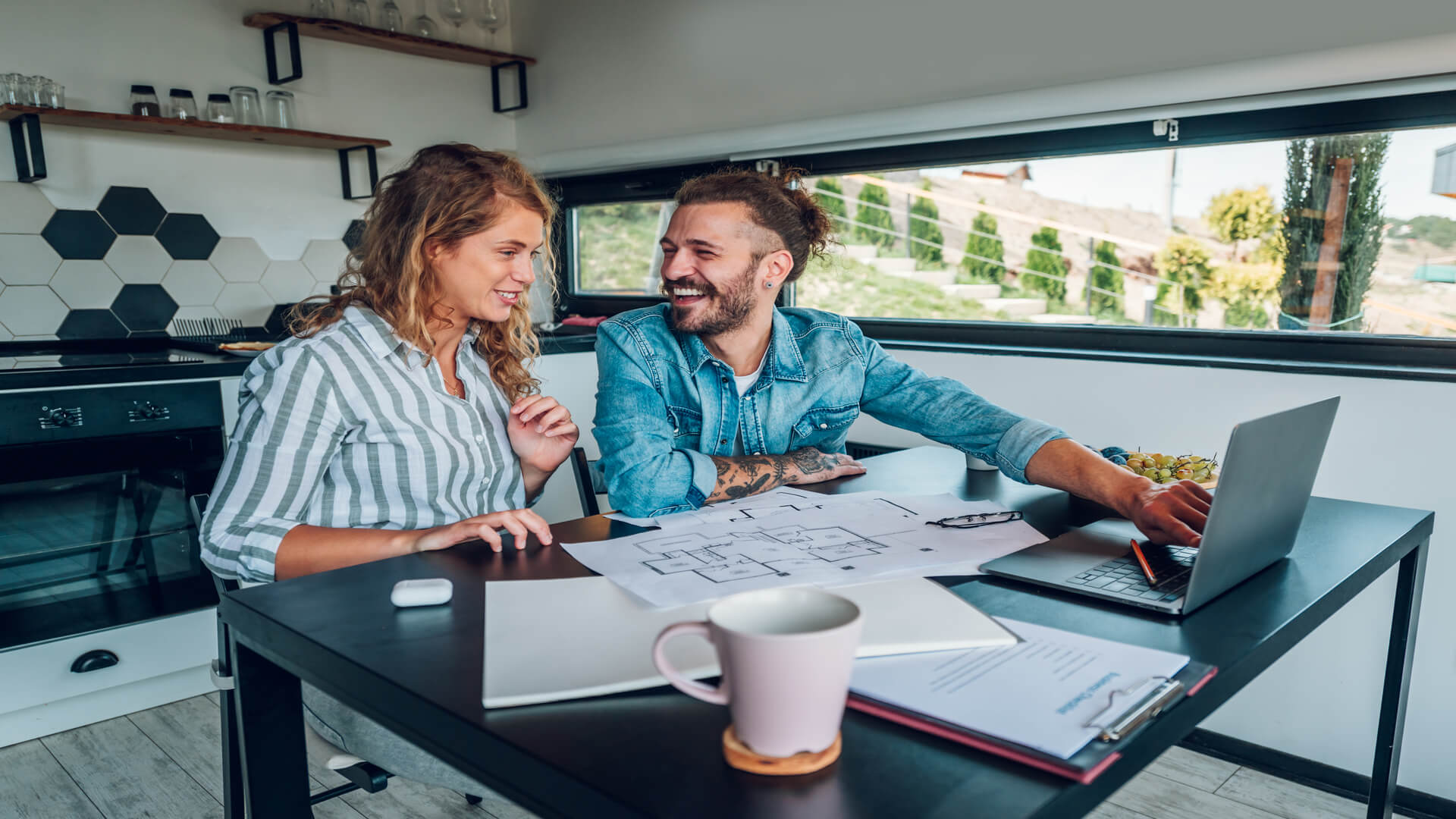 brdiging loan broker brisbane couple discussing home plans in the kitchen