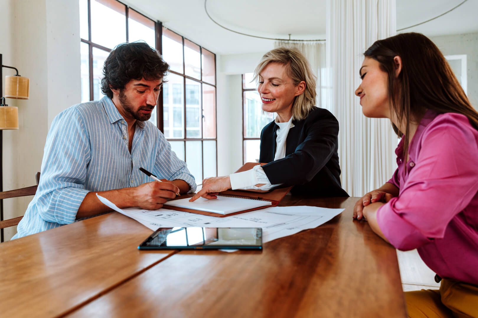 Bridging loan broker in Melbourne advising a couple on buy-before-you-sell property finance strategy in a modern home setting.