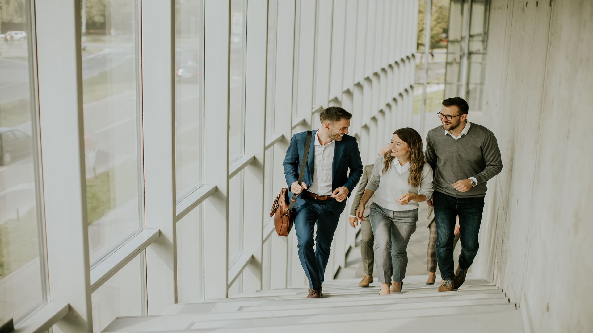 Homeowners discussing property transition options while walking upstairs, symbolising buy-before-you-sell bridging finance.